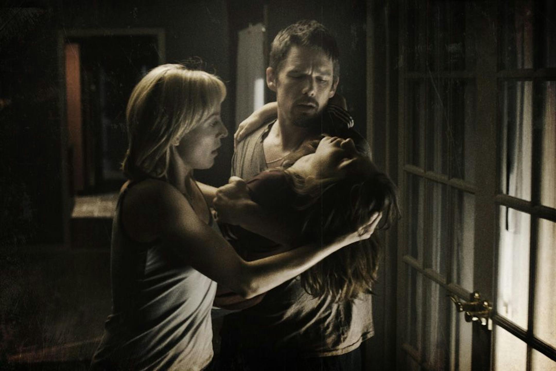 Juliet Rylance, left, Ethan Hawke, right, and Michael Hall D'Addario in "Sinister."