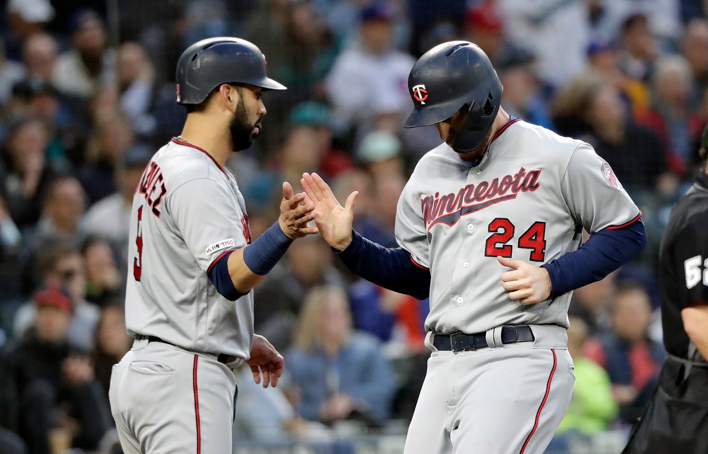 The Twins' Marwin Gonzalez greeted C.J. Cron (24) after the two scored in the fifth inning in a 7-1 victory over the Mariners on Friday in Seattle.