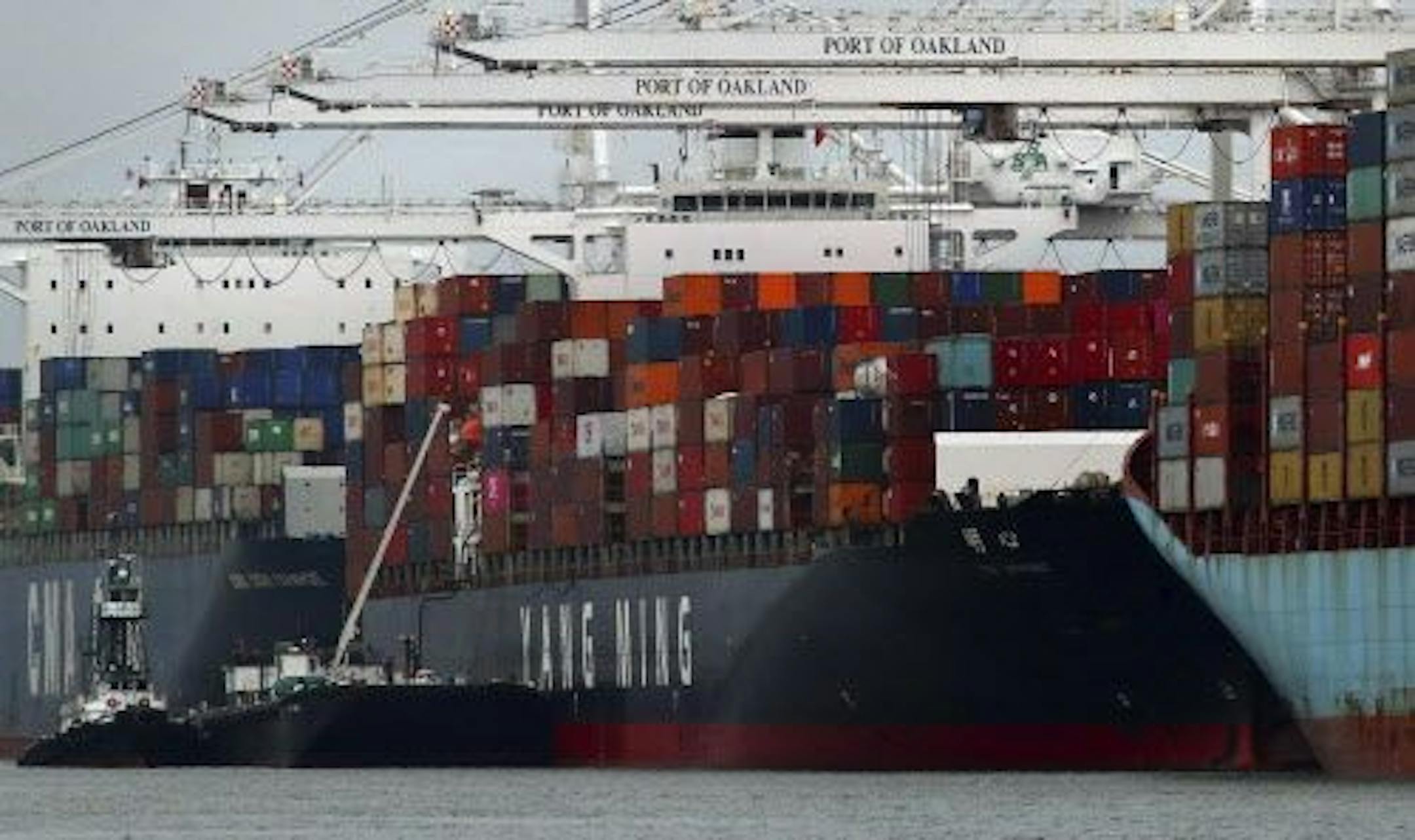 The Yang Ming shipping line container ship Ym Utmost is unloaded at the Port of Oakland on Monday, July 2, 2018, in Oakland, Calif. The Trump administration on Friday, July 6, 2018, will start imposing tariffs on $34 billion in Chinese imports.