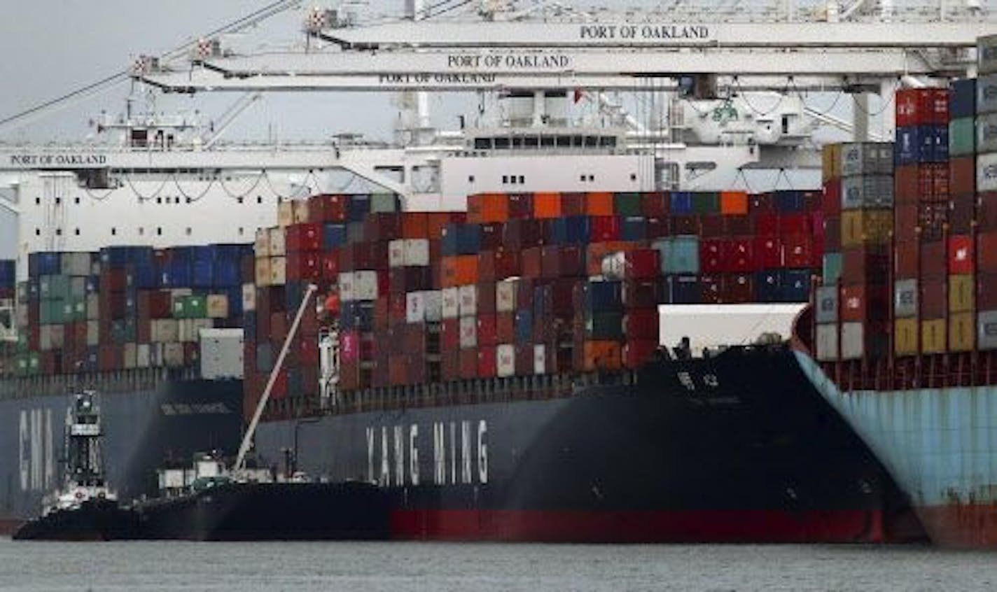 The Yang Ming shipping line container ship Ym Utmost is unloaded at the Port of Oakland on Monday, July 2, 2018, in Oakland, Calif. The Trump administration on Friday, July 6, 2018, will start imposing tariffs on $34 billion in Chinese imports.