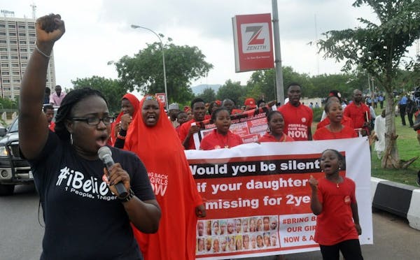 People march during a protest calling on the government to rescue the kidnapped girls of the government secondary school who were abducted two years a