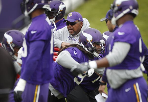 Andre Patterson defensive line coach watched players rn trough drills during the Vikings first organized full-team practice of the offseason at Winter