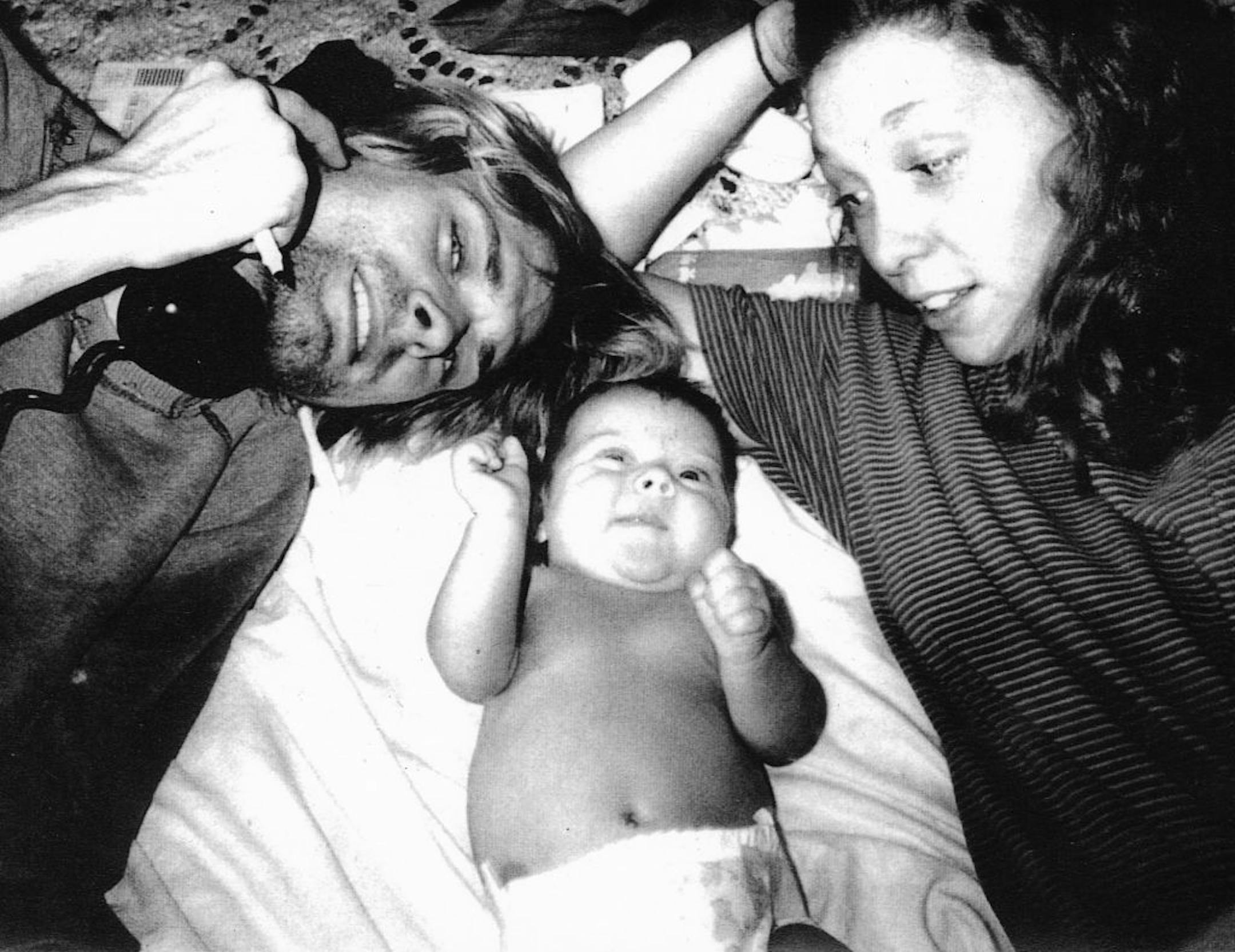 Hole drummer Patty Schemel with Kurt Cobain and his daughter, Frances Bean, in a 1992 snapshot that's part of the new documentary "Hit So Hard."