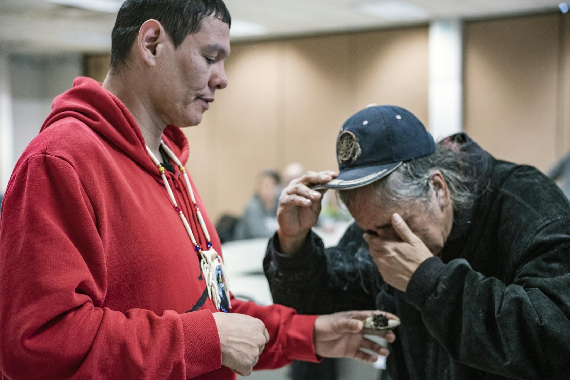 John Diver helped smudge a fellow Fond du Lac Reservation member with sage. Diver has also been involved in the search for American Indians.