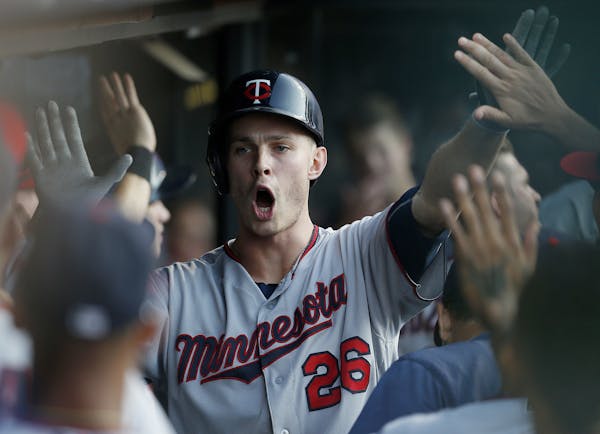 Minnesota Twins' Max Kepler (26) celebrates in the dugout after hitting a two-run home run off Cleveland Indians starting pitcher Carlos Carrasco duri