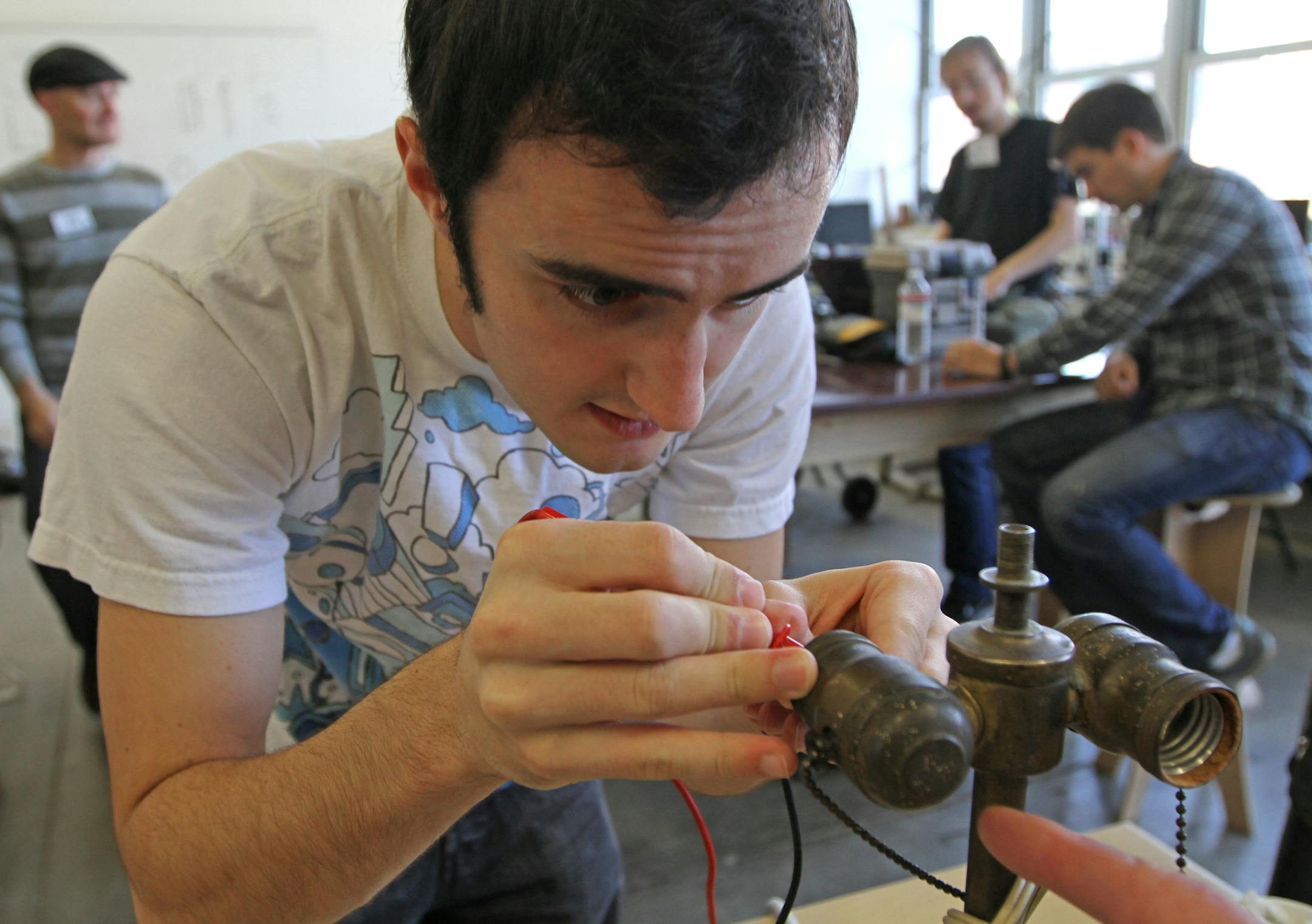 Jimmy Lynch fixed a lamp during the Hennepin County Fix-It Clinics where residents bring in small household appliances, electronics, clothing and mobile devices for repair. The Fix-It Clinic as held at The Mill, a workshop in north Minneapolis on 12/8/12.] Bruce Bisping/Star Tribune bbisping@startribune.com Jimmy Lynch/source.