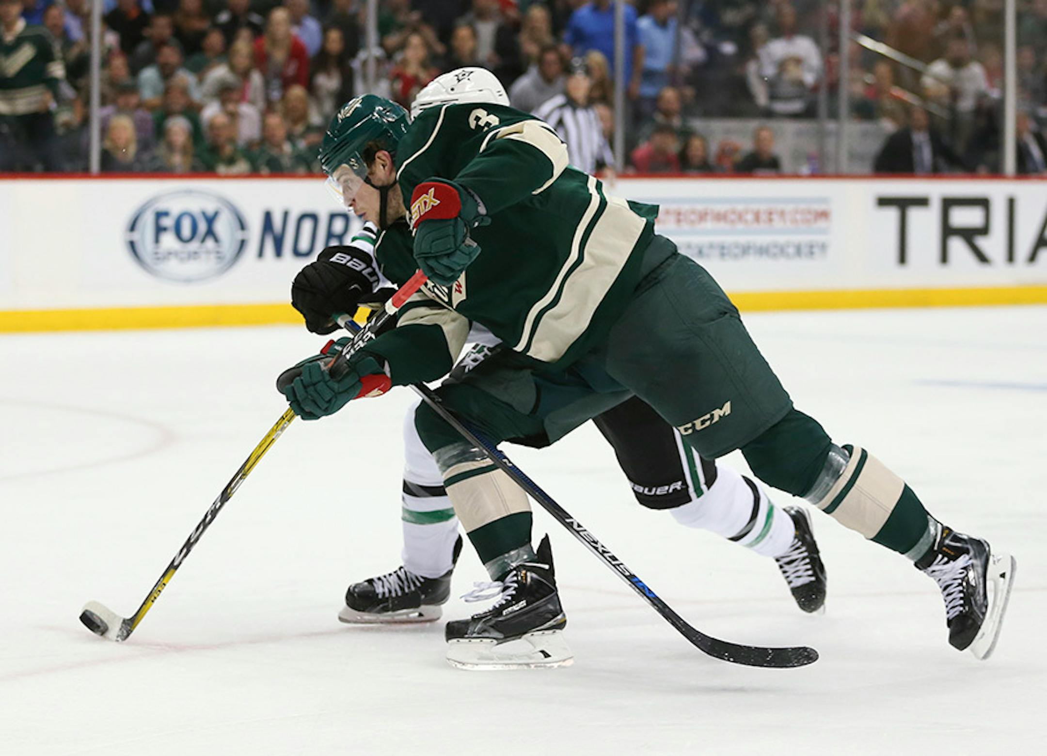 Wild center Charlie Coyle (3) beat Dallas Stars defenseman Alex Goligoski (33) to the puck in the second period Monday night.