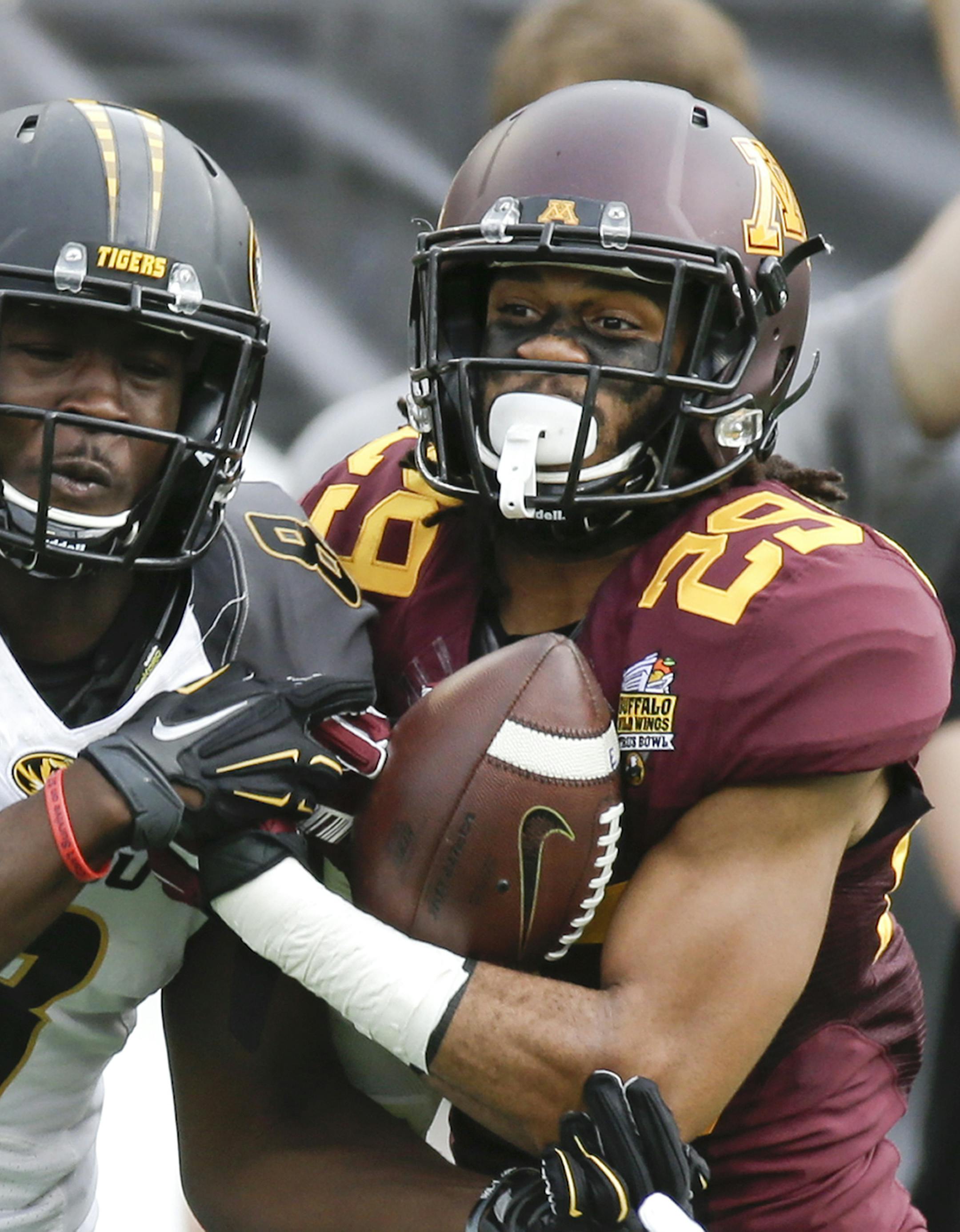 Minnesota defensive back Briean Boddy-Calhoun (29) intercepts a pass intended for Missouri wide receiver Darius White (8) during the first half of the Citrus Bowl NCAA college football game in Orlando, Fla., Thursday, Jan. 1, 2015. (AP Photo/John Raoux) ORG XMIT: MIN2015010114201933