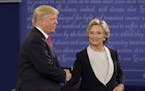 Republican presidential nominee Donald Trump shakes hands with Democratic presidential nominee Hillary Clinton during the second presidential debate a
