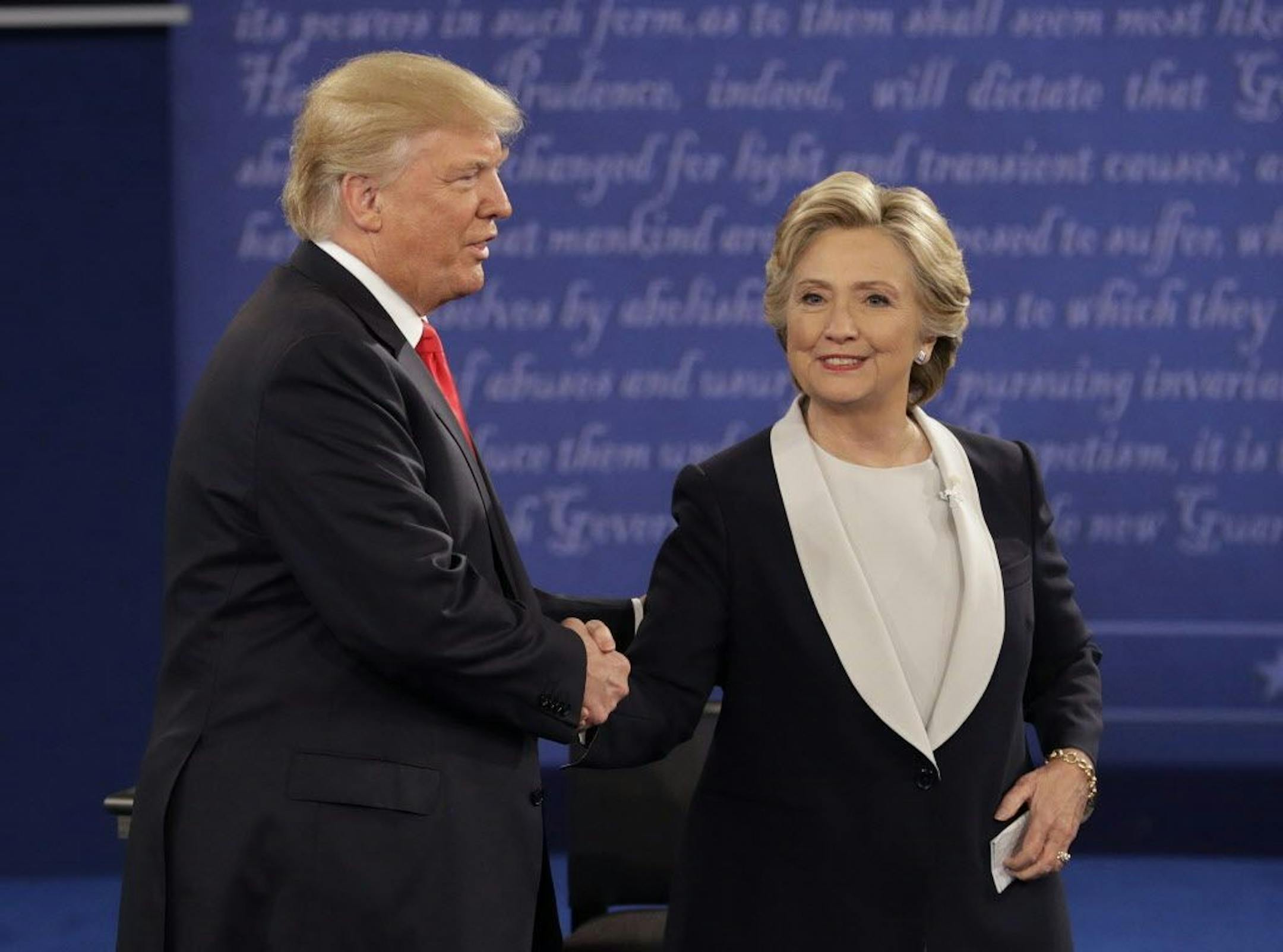Republican presidential nominee Donald Trump shakes hands with Democratic presidential nominee Hillary Clinton during the second presidential debate at Washington University in St. Louis, Sunday, Oct. 9, 2016.