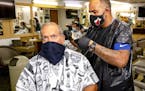 Palmetto Bay resident Jesse Jimenez, 68, has his hair cut by barber Rafale Cruz, 38, at Pete's Barber Shop in Pinecrest, Fla., on Monday, May 18, 2020