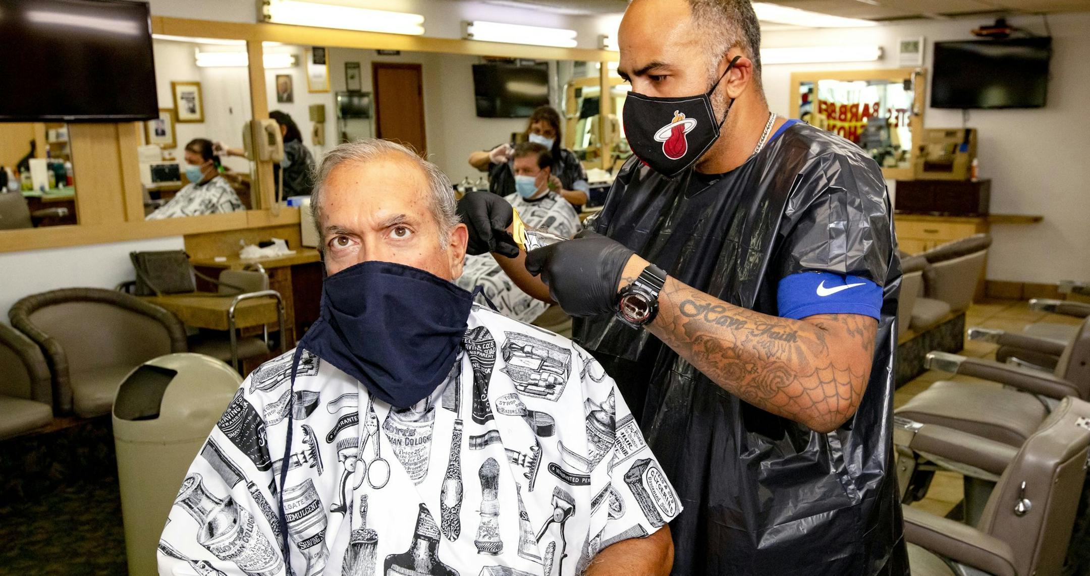 Palmetto Bay resident Jesse Jimenez, 68, has his hair cut by barber Rafale Cruz, 38, at Pete's Barber Shop in Pinecrest, Fla., on Monday, May 18, 2020.(Daniel A. Varela/Miami Herald/TNS) ORG XMIT: 1665381