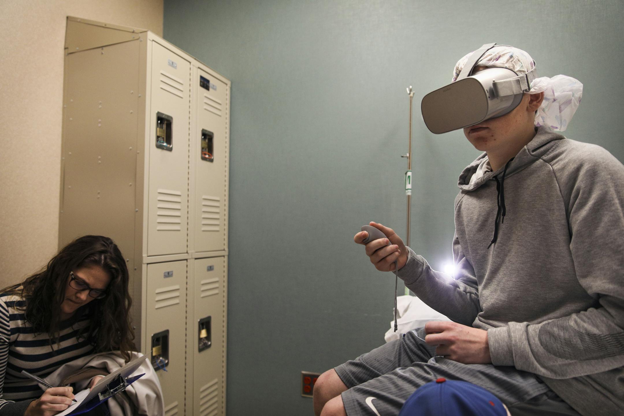 Ryan Ohmann tested a virtual reality headset, above, for his MRI. Mother Angela is at left.