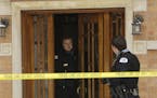 Chicago police officials investigate a triple homicide in Chicago Saturday, Feb. 17, 2007. Three women were found bludgeoned to death with a hammer in