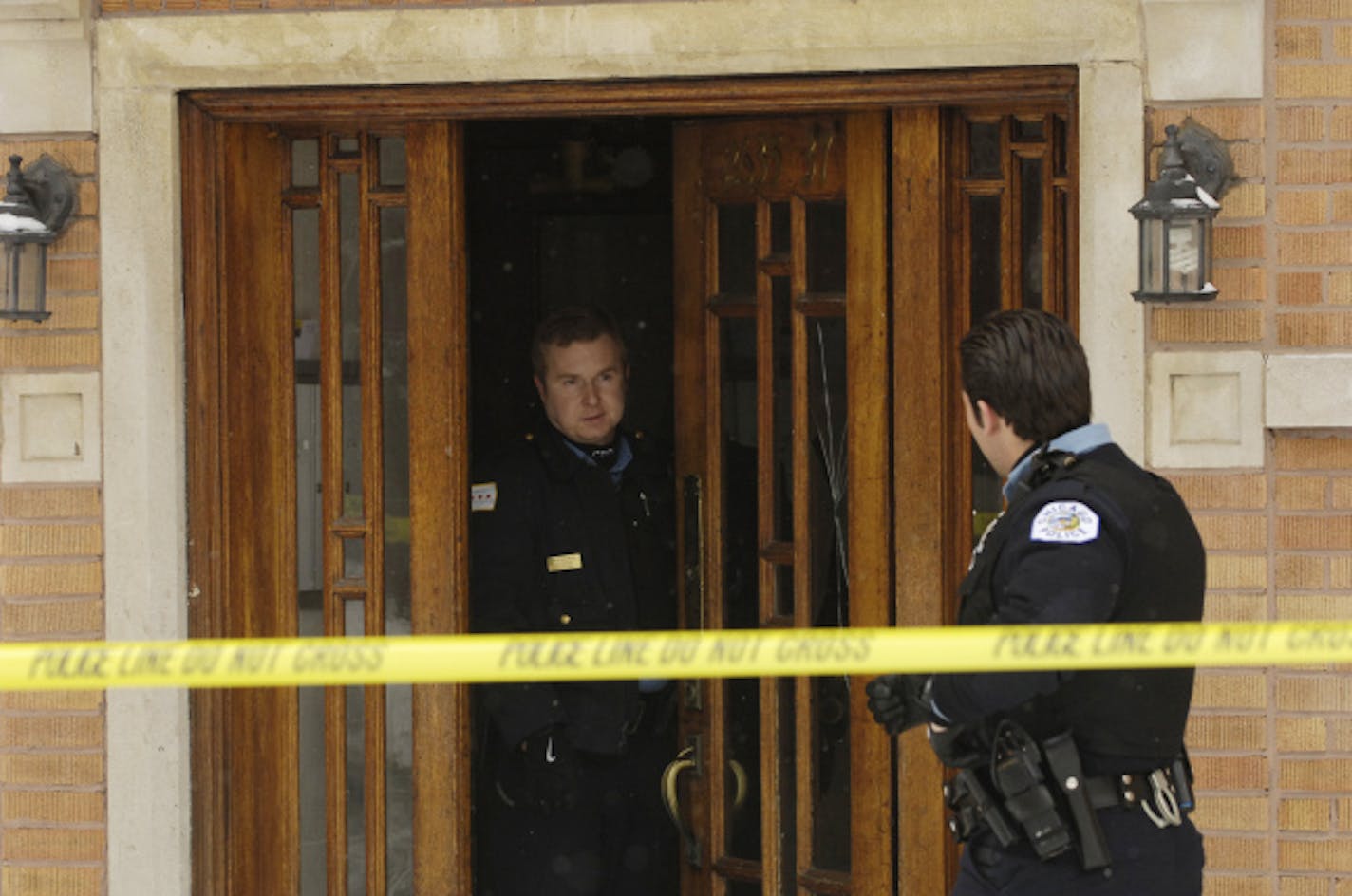 Chicago police officials investigate a triple homicide in Chicago Saturday, Feb. 17, 2007. Three women were found bludgeoned to death with a hammer in two apartments on the city's far North Side, and police had a suspect in custody Sunday.