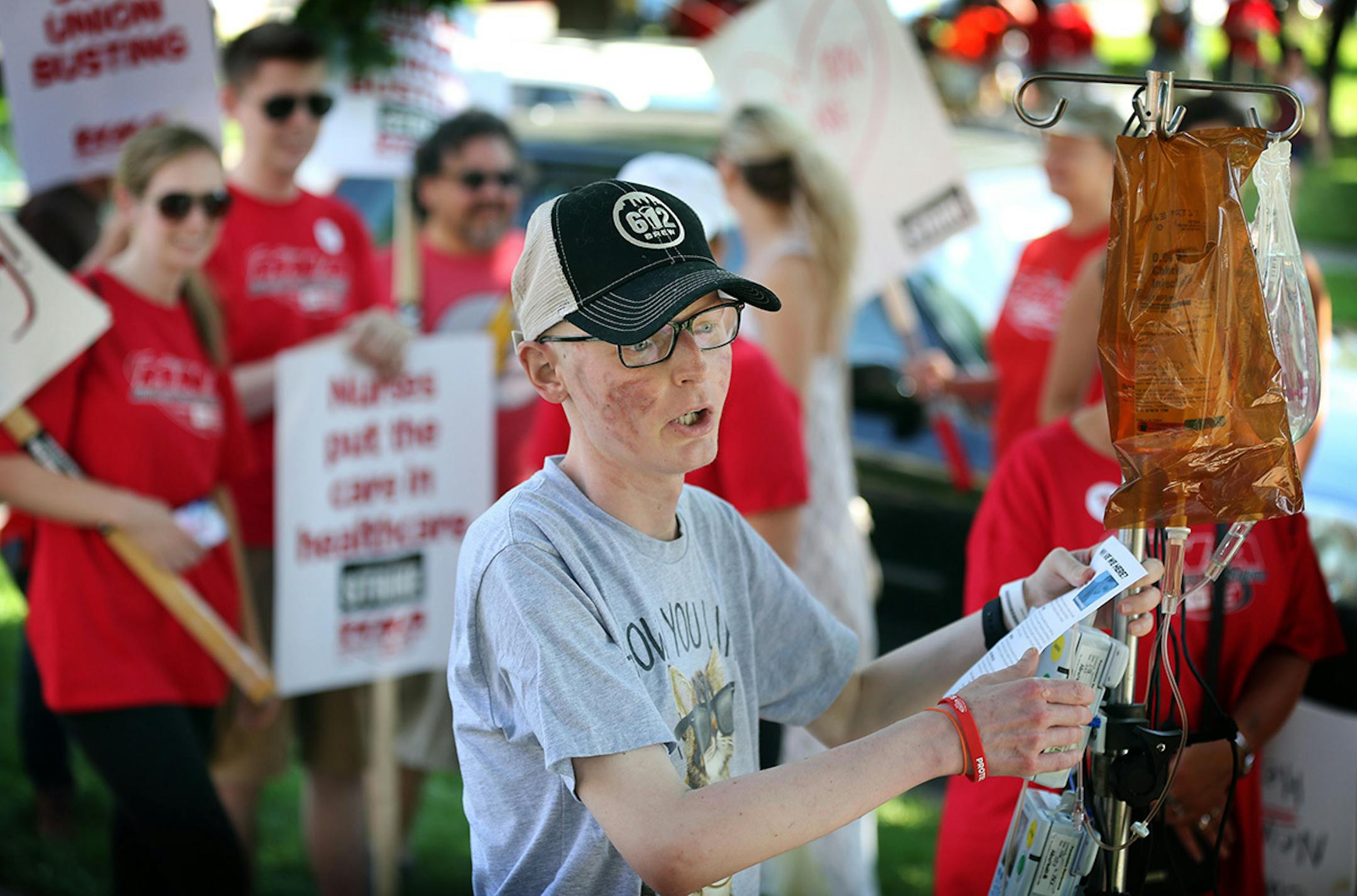 Joe Skubic 27, of Maple Grove has been a cancer patient at Abbott for past two years. On Sunday he came out of his hospital room to show support for his nurse. Thousands of nurses walked around Abbott Northwestern on the first day of the strike Sunday June 19, 2016 in Minneapolis, MN.