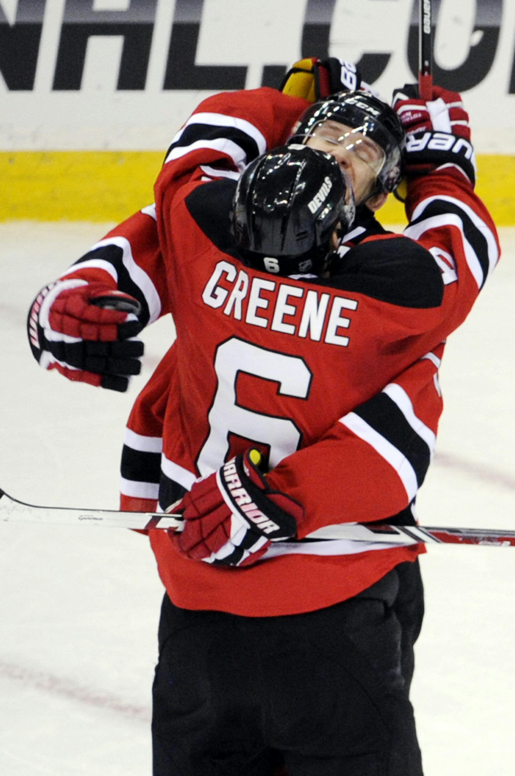 New Jersey Devils' Andy Greene (6) and Patrik Elias celebrates Greene's goal during the overtime period of an NHL hockey game Thursday, March 20, 2014, in Newark, N.J. The Devils won 4-3. (AP Photo/Bill Kostroun)