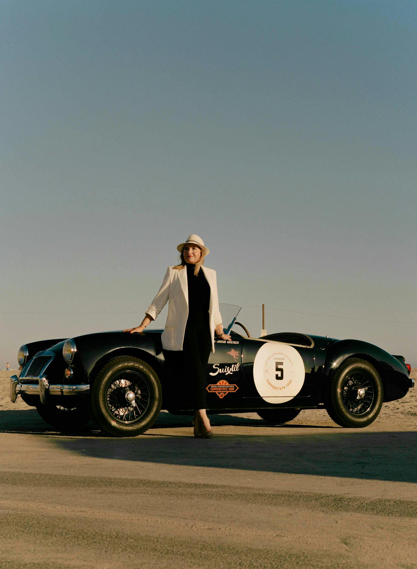 Caroline Cassini stands for a portrait with her partner's MG at the beach in Marina Del Rey, Calif. on Aug. 8, 2021. Cassini, now 29, may have startled some neighbors in West Orange, N.J., when she announced that, rather than applying to an East Coast liberal arts college, she would follow a path charted by her family and pursue a curriculum in automotive restoration at the Academy of Art University in San Francisco. (Tracy Nguyen/The New York Times)