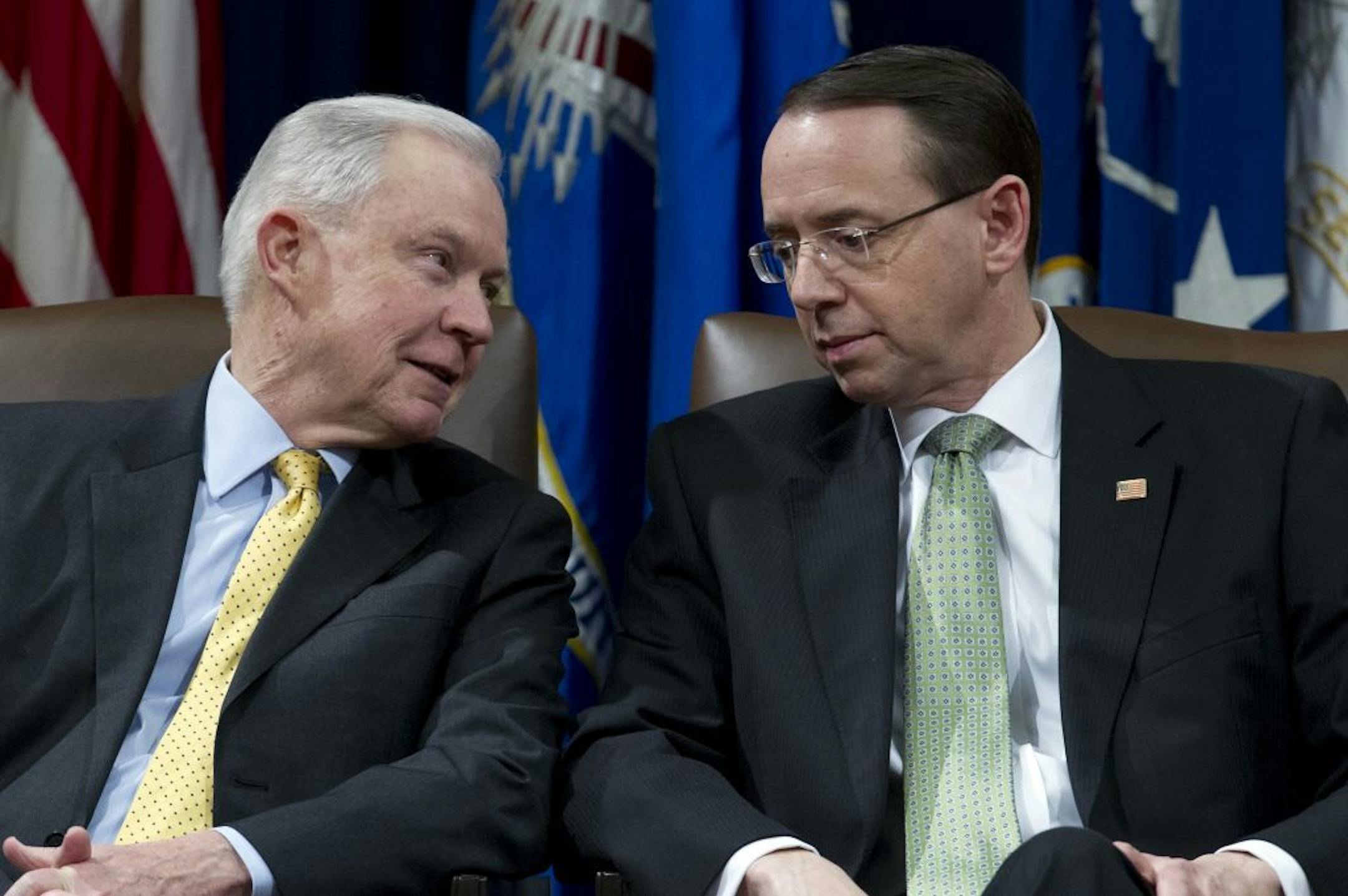 Attorney General Jeff Sessions speaks with Deputy Attorney General Rod Rosenstein during the opening ceremony of the summit on Efforts to Combat Human Trafficking at Department of Justice in Washington, Friday, Feb. 2, 2018. President Donald Trump, dogged by an unrelenting investigation into his campaign's ties to Russia, lashes out at the FBI and Justice Department as politically biased ahead of the expected release of a classified Republican memo criticizing FBI surveillance tactics.