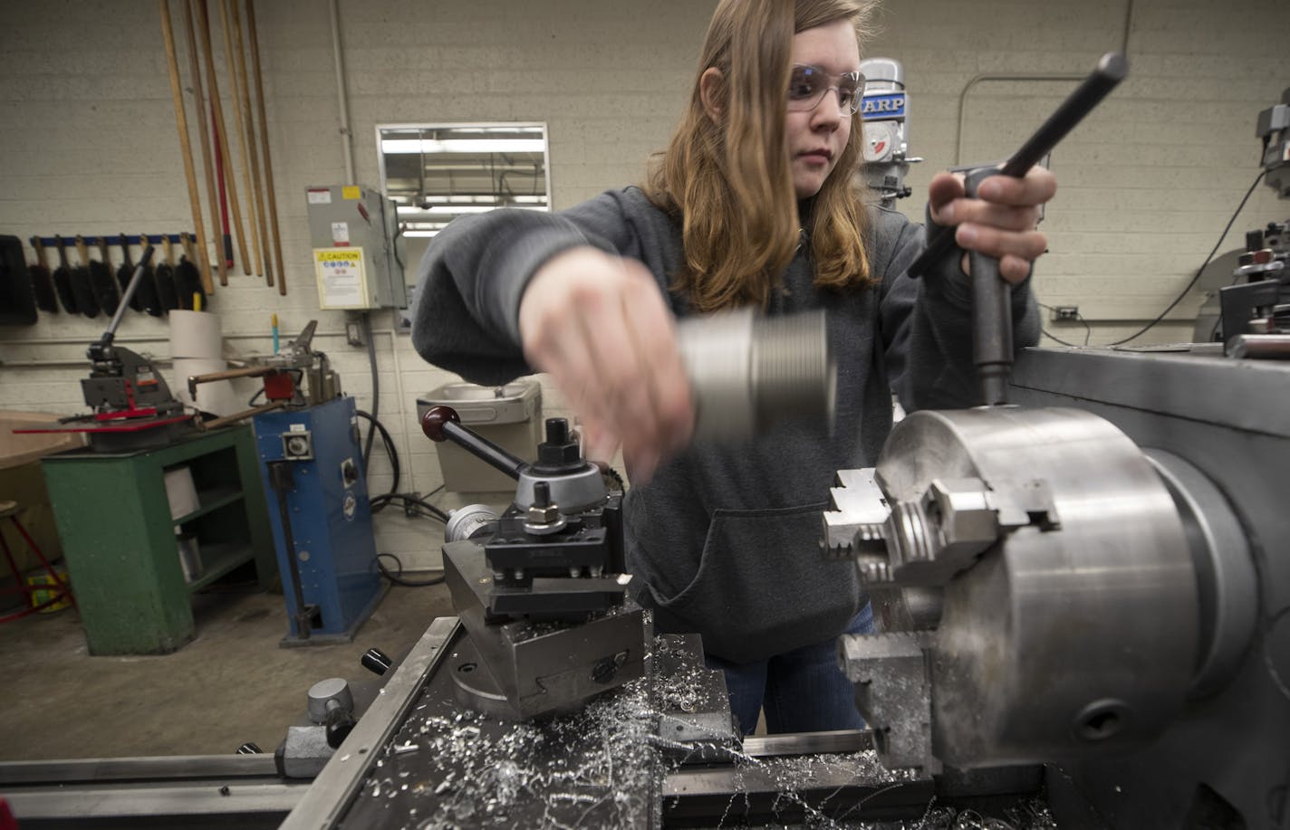 Catie Lonergan, a senior at St. Francis High School, on Monday made parts for MnDOT that will be used on street light fixtures.