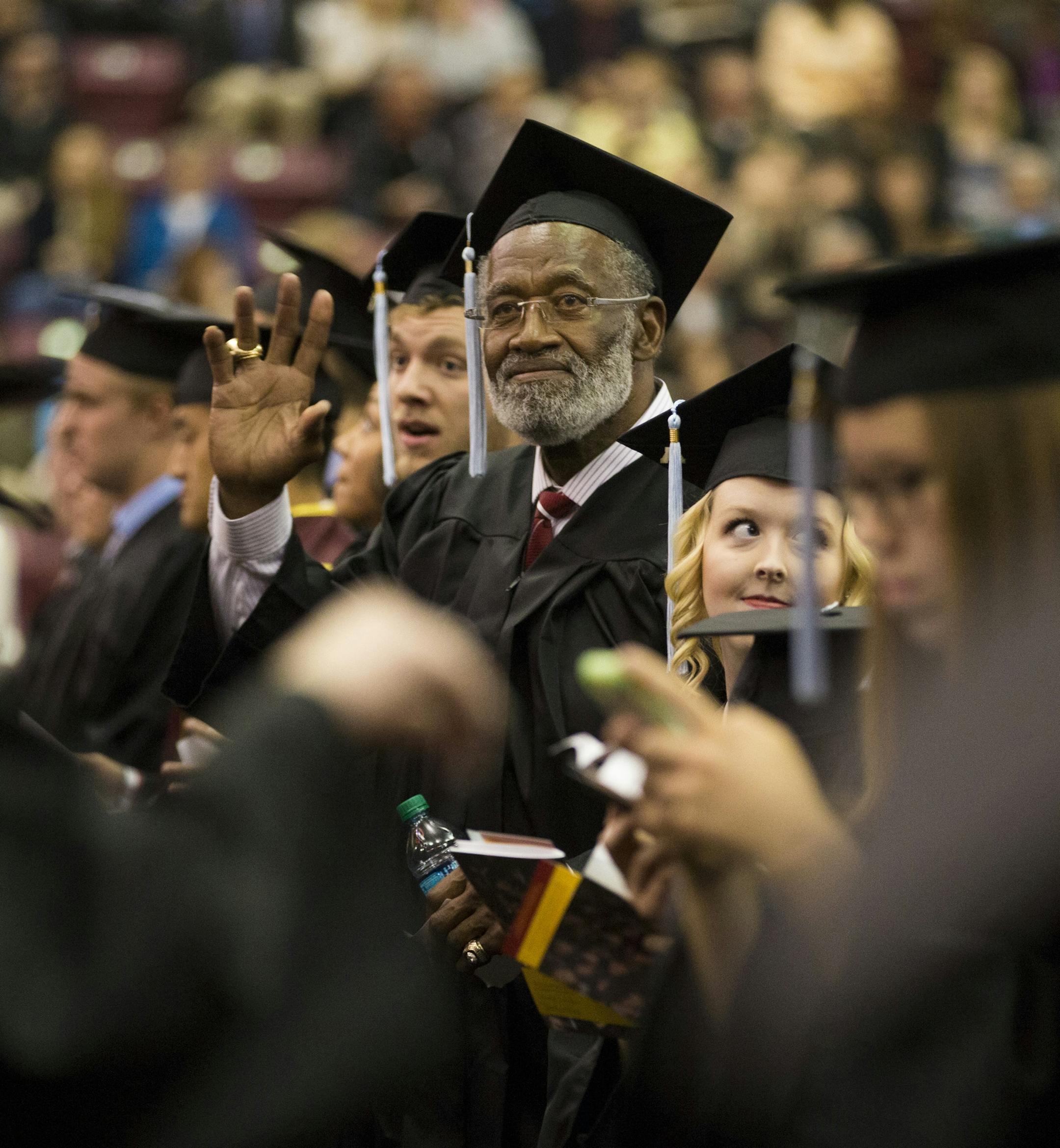 Former Gophers great and Pro Football Hall of Famer Bobby Bell waved to family as he waited to get his diploma as he graduated college on Thursday, May 14, 2015, at Mariucci Arena at the University of Minnesota in Minneapolis, Minn. ] RENEE JONES SCHNEIDER • reneejones@startribune.com Bobby Bell, former Gophers great and Pro Football Hall of Famer, returned to campus 50-some years later to finally graduate Thursday.