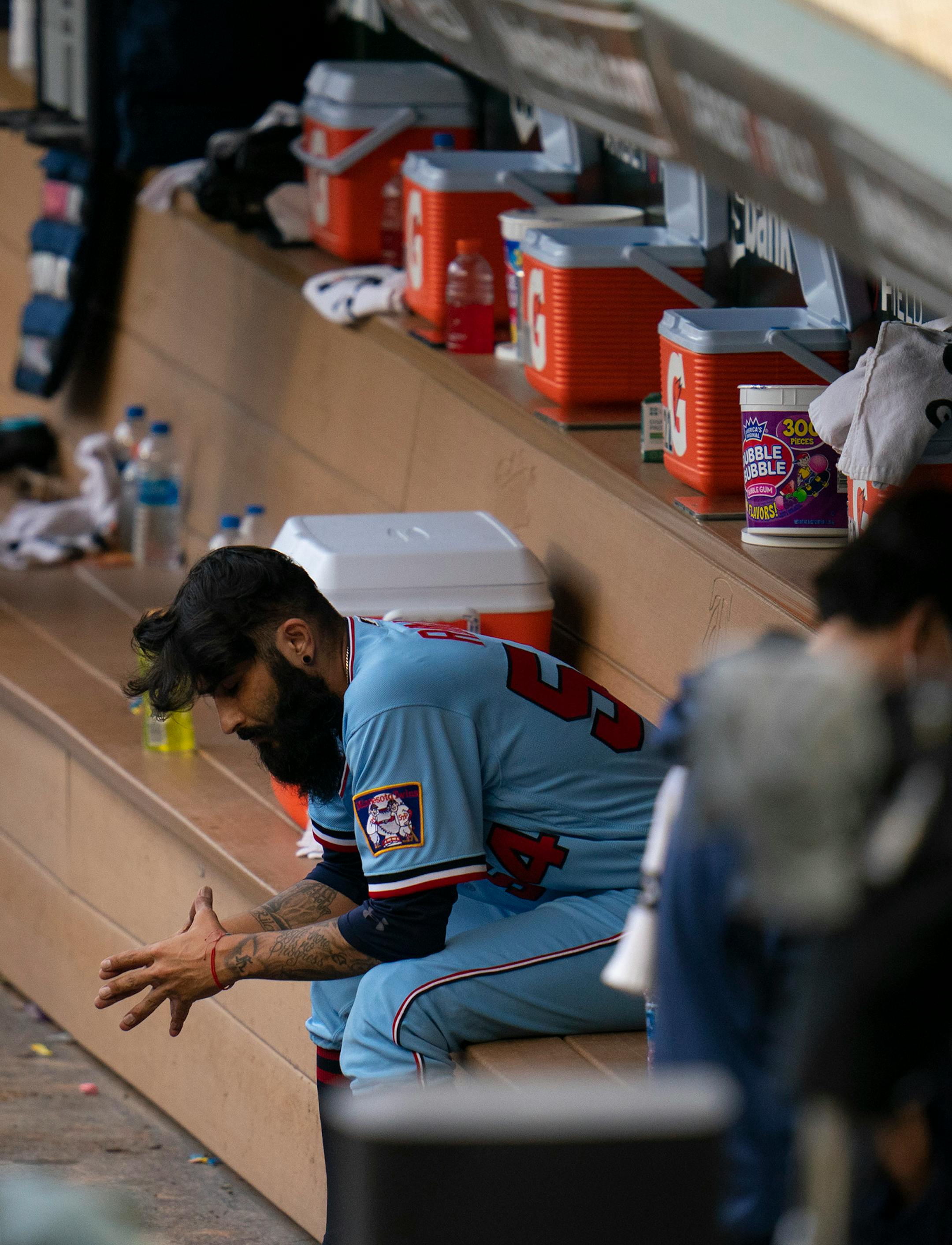 Minnesota Twins relief pitcher Sergio Romo sat on the bench after being taken out in the game in the 10th inning.