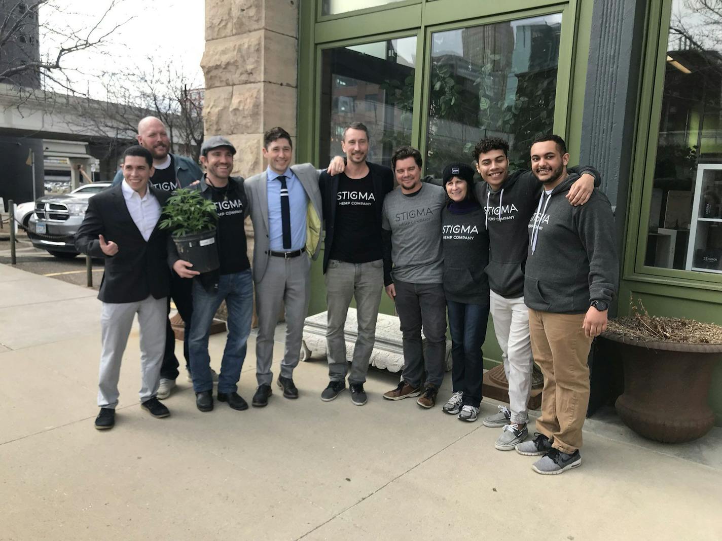 Minneapolis Mayor Jacob Frey, fourth from left, poses with members of the team behind Stigma, a new store selling hemp and CBD products in the North Loop. Stigma founder Josh Maslowski is to his right.