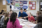 Brent Wathke, a social studies teacher, watches his students as they discuss the election at DeLong Middle School in Eau Claire, Wis., Oct. 13, 2016. 