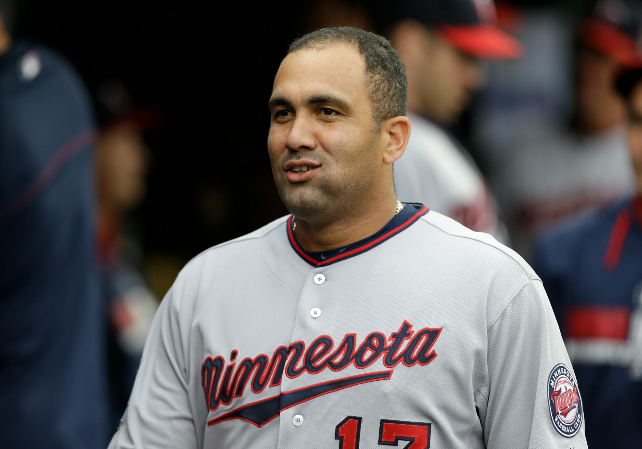 Minnesota Twins designated hitter Kendrys Morales smiles in the dugout against the Detroit Tigers in the first inning of a baseball game in Detroit, Friday, June 13, 2014. (AP Photo/Paul Sancya)