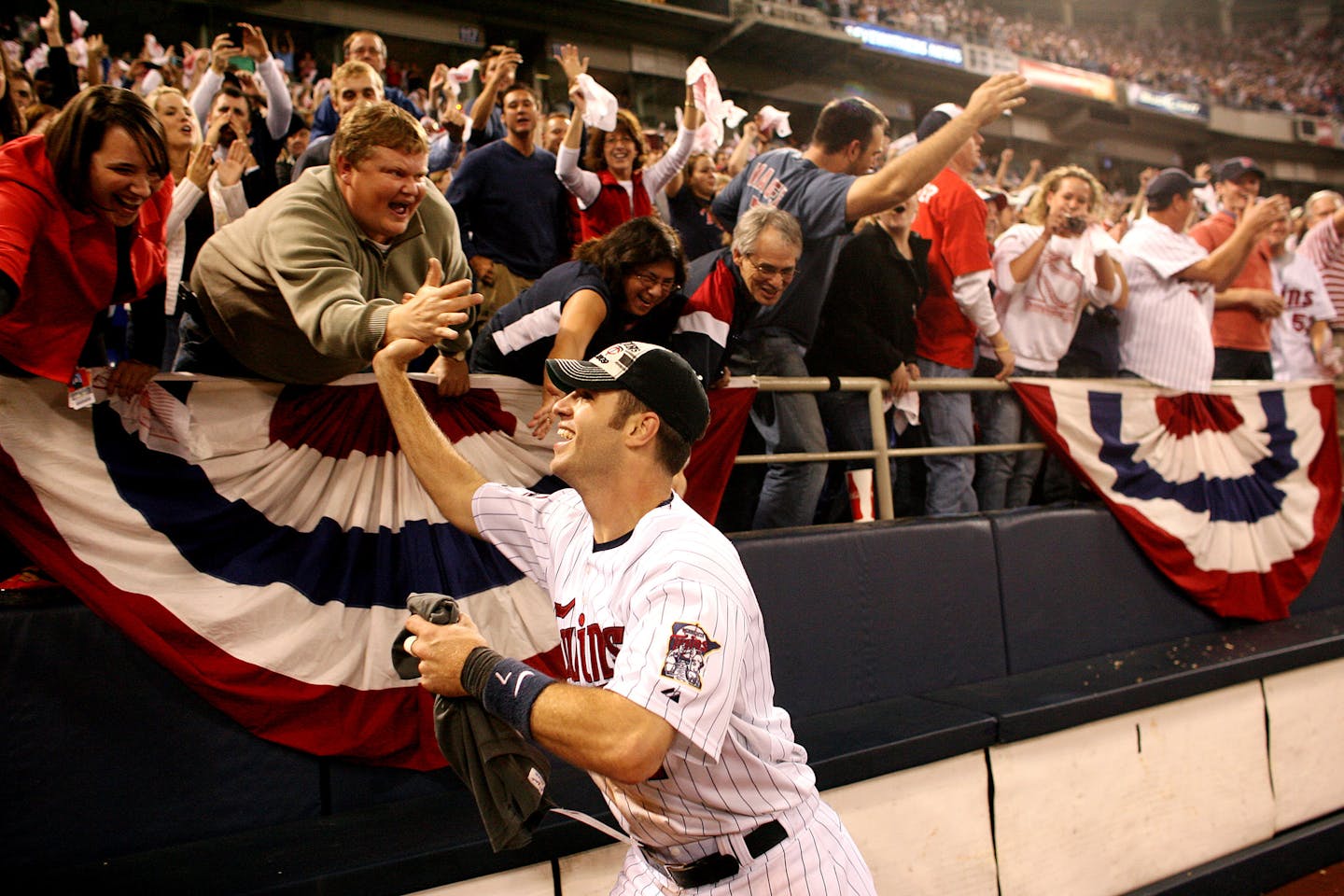 Twins catcher Joe Mauer celebrates with fans after Minnesota defeated the Detroit Tigers 6-5 to win the American League Central division title in extr
