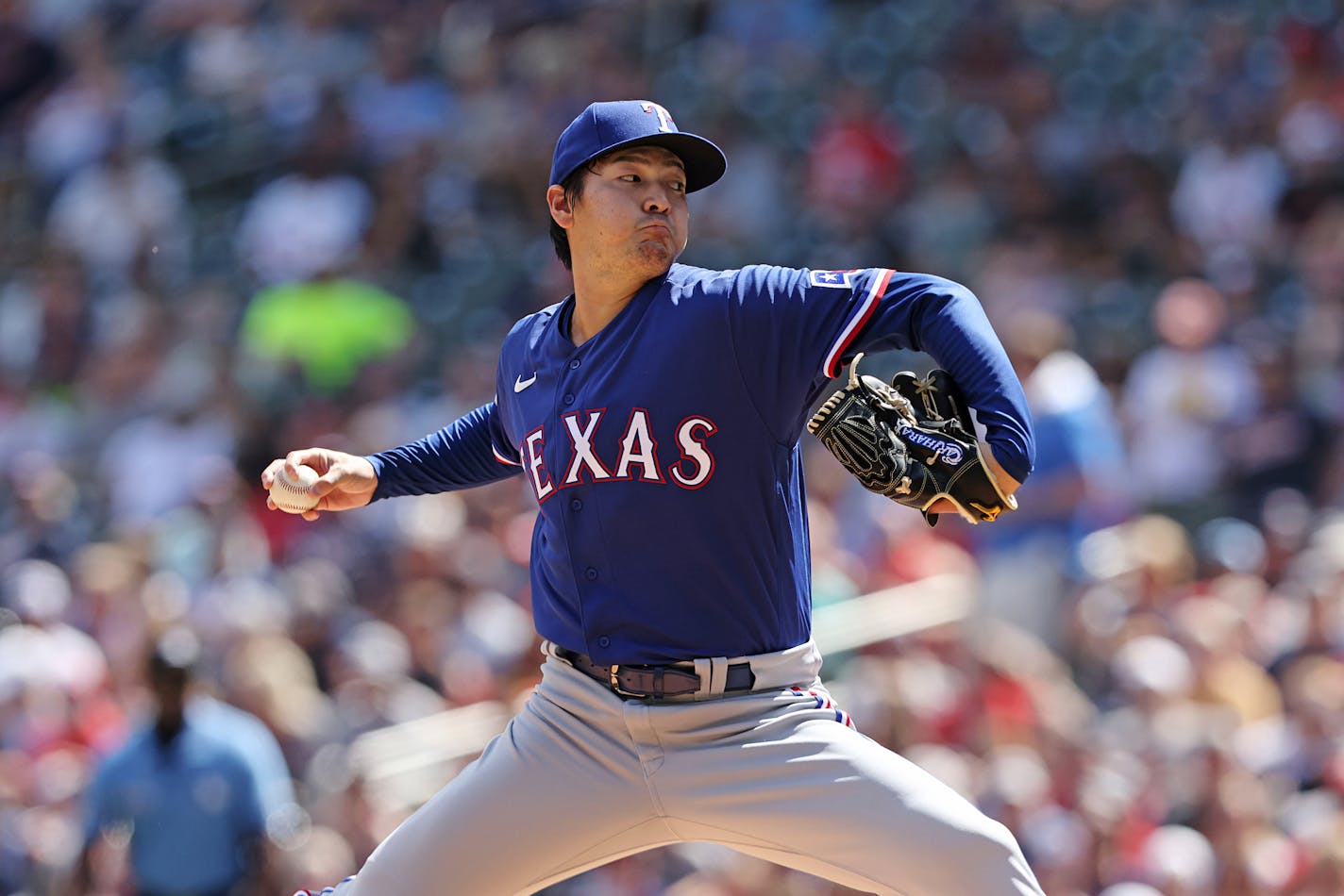 Texas Rangers starting pitcher Kohei Arihara (35) throws during the first inning of a baseball game against the Minnesota Twins, Sunday, Aug. 21, 2022, in Minneapolis. (AP Photo/Stacy Bengs)