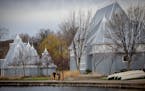 Park goers walk past the newly renovated Lake Harriet Bandshell in Minneapolis Thursday.