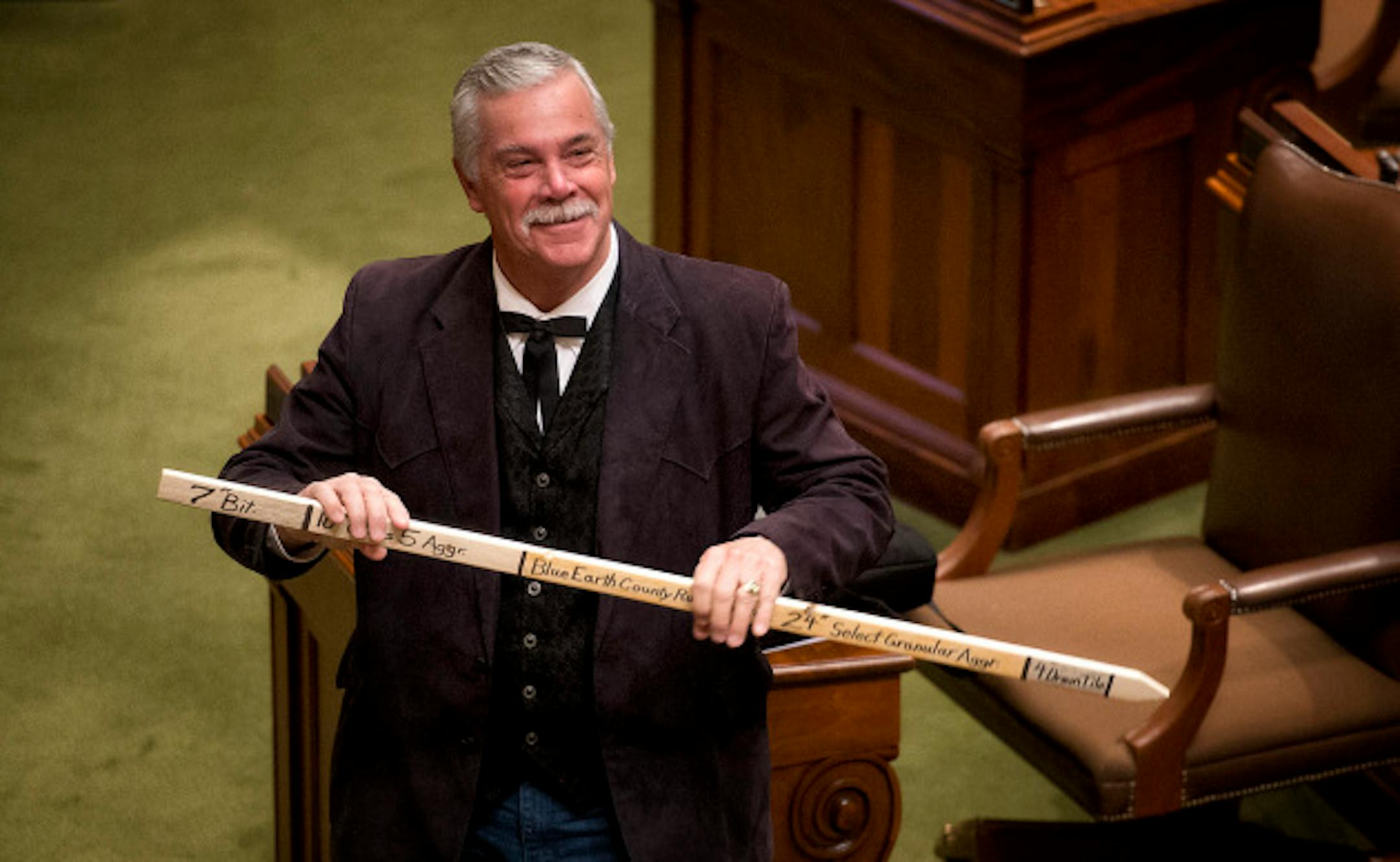 Rep. Tony Cornish, R-Vernon Center, carried a big stick on to the House floor today to illustrate a dispute between MNDOT and Waseca and Steele Counties.  MNDOT wants to turn over State Highway 14 to the counties but won't improve it as it has in other places.   and  Wednesday, April 24, 2013.     ]       GLEN STUBBE * gstubbe@startribune.com
