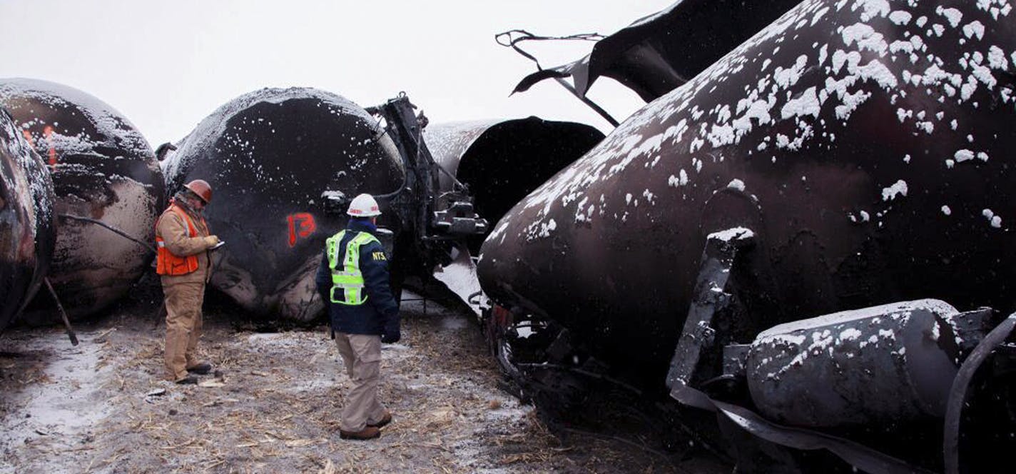 In a handout photo, Robert Sumwalt, right, of the National Transportation and Safety Board, investigates a rail accident in Casselton, N.D., Jan. 1, 2014. No one was hurt as a train carrying high-grade crude oil from the state's Bakken field struck a derailed grain train, but the incident, and previous accidents, have prompted North Dakota politicians to rally for stricter federal railroad safety regulations. (NTSB via The New York Times) -- FOR EDITORIAL USE ONLY. ORG XMIT: MIN2014021912580365