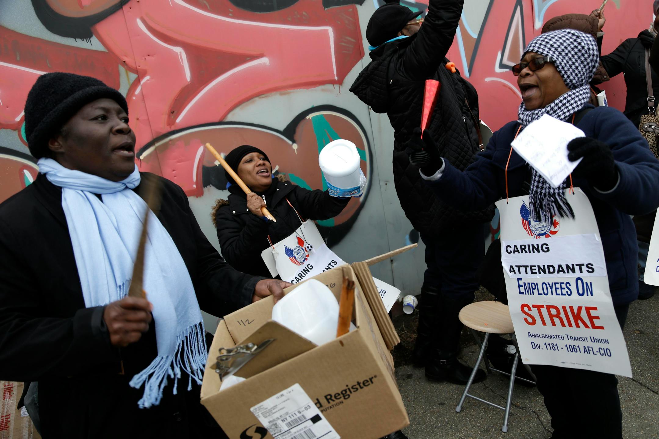 School bus attendants and their supporters chant and drum while walking a picket line near a bus depot in New York, Thursday, Jan. 17, 2013. New York City's first school bus strike in 34 years entered its second day Thursday with no resolution in sight and tens of thousands of parents scrambling to get their kids to school. Some parents said the strike was wreaking havoc with their schedules. The strike pits the city's need to rein in spiraling costs against the bus drivers' goal of preserving t