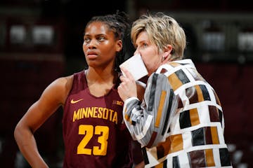 Former Minnesota head coach Marlene Stollings confers with guard Kenisha Bell (23) during a game against Ohio State in 2018.