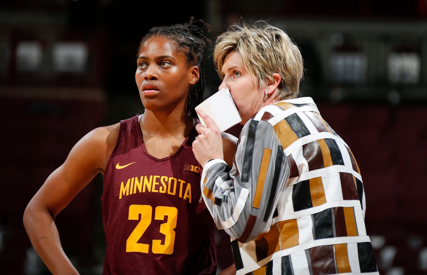 Former Minnesota head coach Marlene Stollings confers with guard Kenisha Bell (23) during a game against Ohio State in 2018.