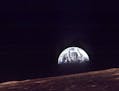 The Earth shines over the horizon of the Moon in this Dec. 24, 1968 photo shot by the astronauts on Apollo 8. Apollo 8 was launched from Cape Canavera