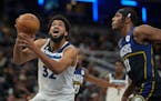 Minnesota Timberwolves center Karl-Anthony Towns (32) shoots in front of Indiana Pacers center Myles Turner (33) during the first half of an NBA baske