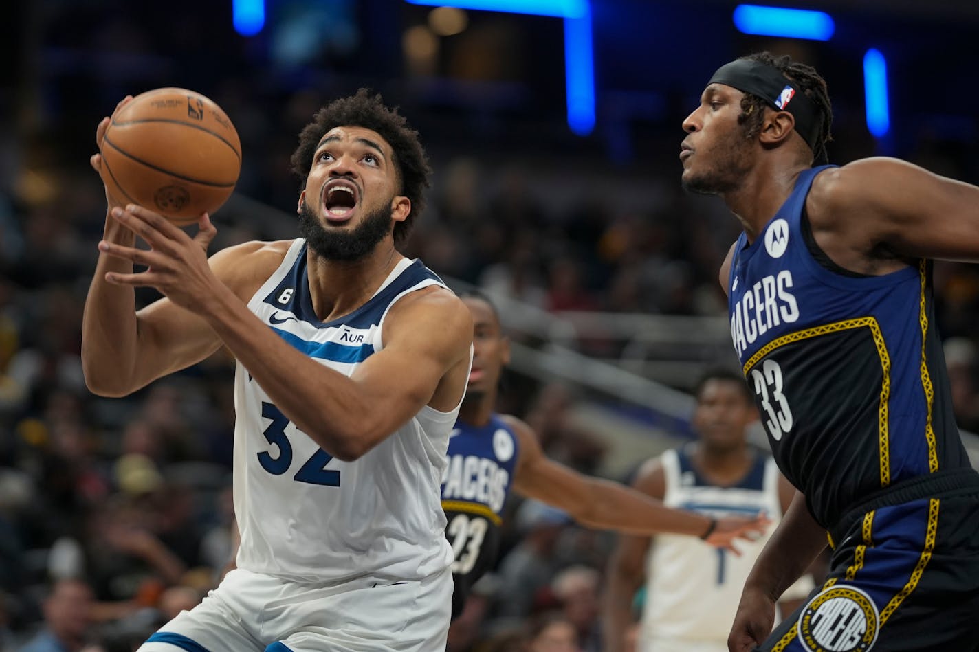 Minnesota Timberwolves center Karl-Anthony Towns (32) shoots in front of Indiana Pacers center Myles Turner (33) during the first half of an NBA basketball game in Indianapolis, Wednesday, Nov. 23, 2022. (AP Photo/AJ Mast)