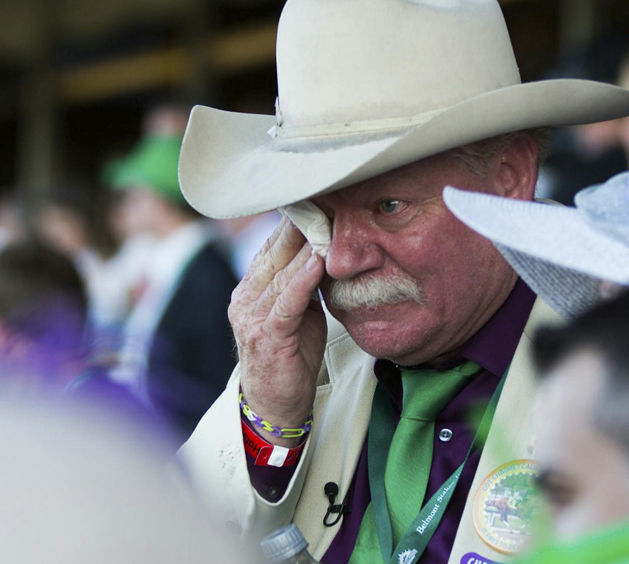 Steve Coburn, co-owner of California Chrome, wipes a tear after his horse finished in a dead heat for fourth at the 146th running of the Belmont Stakes, in Elmont, N.Y., June 7, 2014. Coburn later said he was upset by having to race against so many horses that had skipped one or both of the Kentucky Derby and Preakness, including Tonalist, the winner here. (Piotr Redlinski/The New York Times)