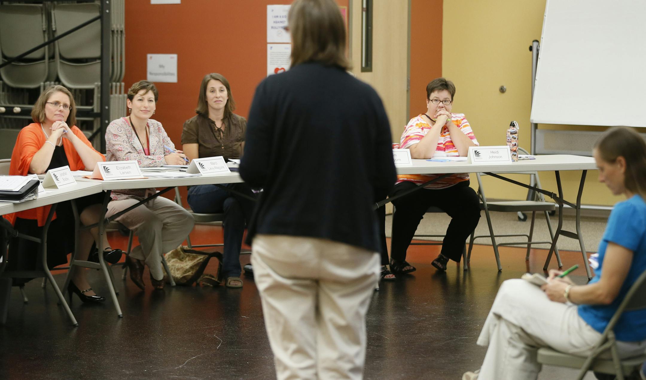 School board members Elizabeth Larsen left , Marci Levy-Maguire, Kim Glogowski, and Heidi Johnson listen to a teacher as she voiced here concern about the lack of increase in pay at Paideia Academy Tuesday August 19 , 2014 in Apple Valley ,MN . ] Jerry Holt Jerry.holt@startribune.com