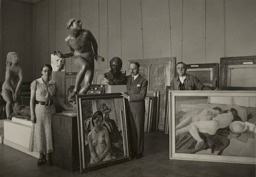 photo of three people and many artworks