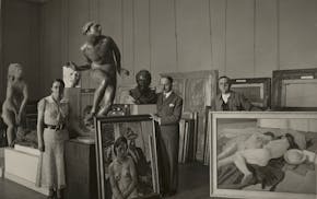 photo of three people and many artworks