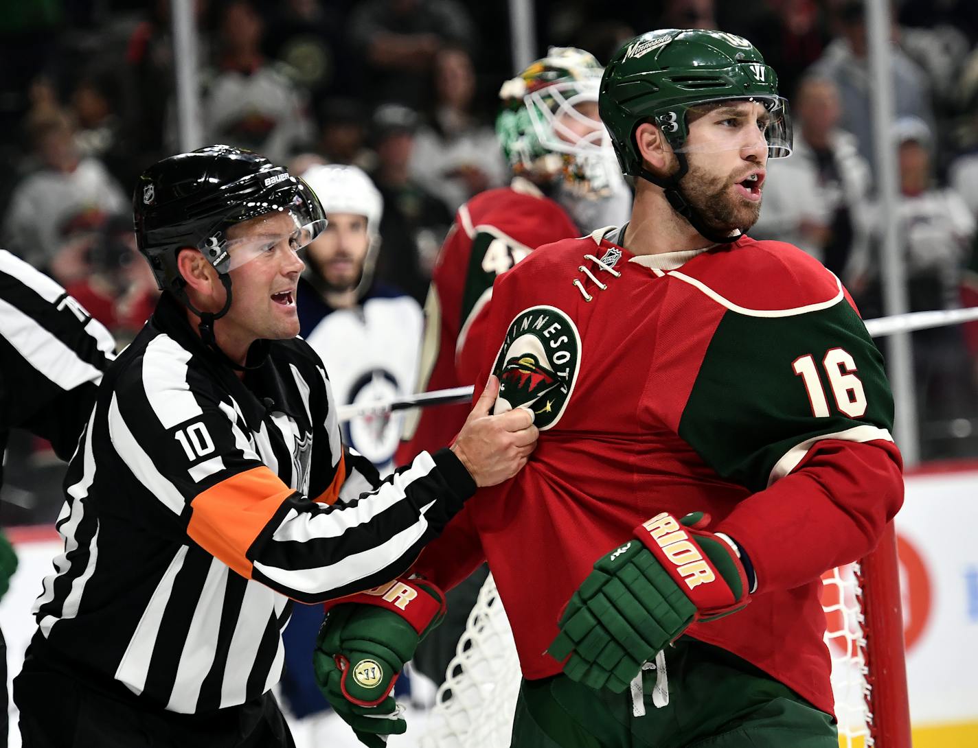 An official pulled Minnesota Wild left wing Jason Zucker (16) away from a scuffle as Zucker trash talked Winnipeg Jets center Adam Lowry (17) after the horn ended Saturday night's preseason game. ] (AARON LAVINSKY/STAR TRIBUNE) aaron.lavinsky@startribune.com The Minnesota Wild played the Winnipeg Jets in their final preseason game on Saturday, Oct. 8, 2016 at Xcel Energy Center in St. Paul, Minn.