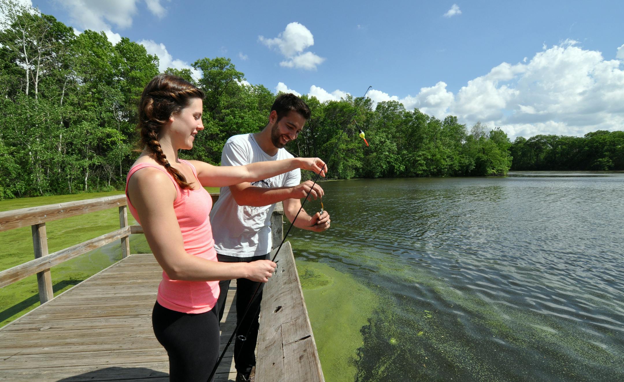 Photo by Liz Rolfsmeier Jaclyn Rgnonti, of Lakeville, and Raj Heck, of Eagan, catch a blue gill at Thomas Lake Park in Eagan.
