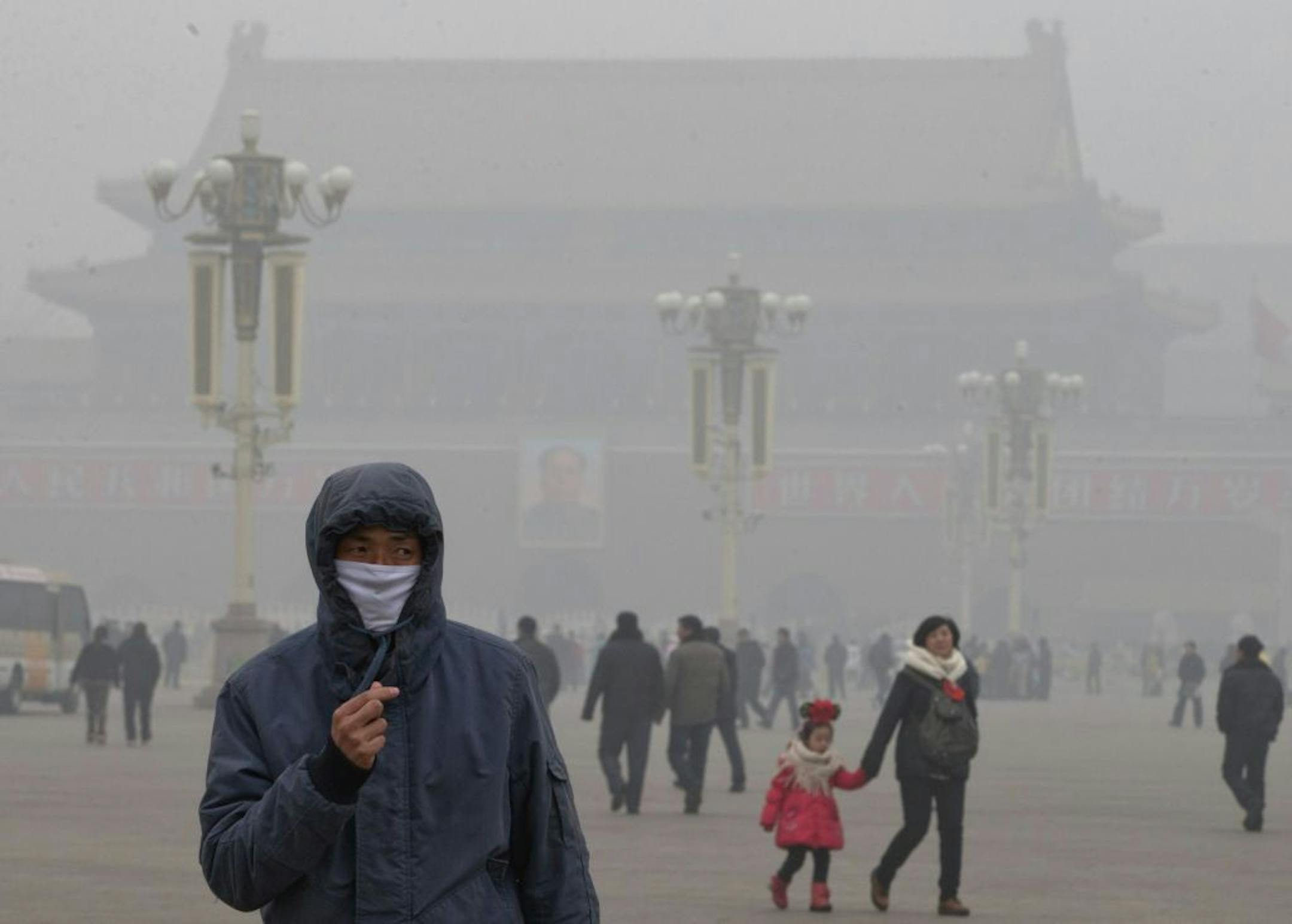 A man wears a mask on Tiananmen Square in thick haze in Beijing Tuesday, Jan. 29, 2013. Extremely high pollution levels shrouded eastern China for the second time in about two weeks.