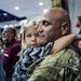 Corrina Eslinger,5, held on tight to her father, Charles, who is a major as they filed in to join a dinner for the soldiers and their families.