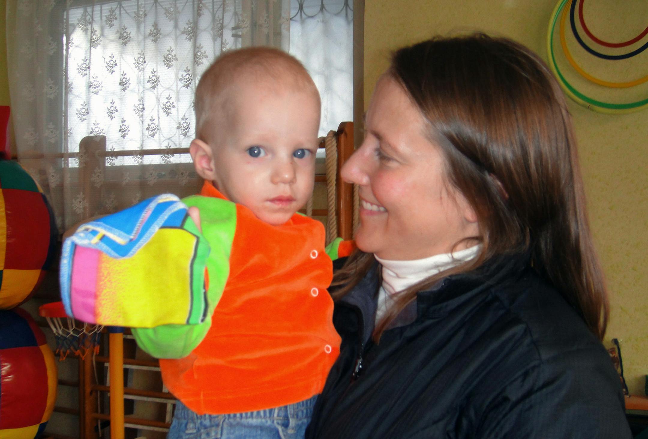 In this 2009 photo provided by the family, Renee Thomas holds Nikolai at an orphanage in Kursk, Russia. On Thursday, Feb. 6, 2014, Thomas went on television in Russia with an emotional appeal for an exception to be made to Russia's year-old ban on adoptions by Americans. She and her husband adopted a boy from Russia in 2008 and refuse to give up long-standing efforts to also adopt Nikolai, their son's biological brother. (AP Photo)