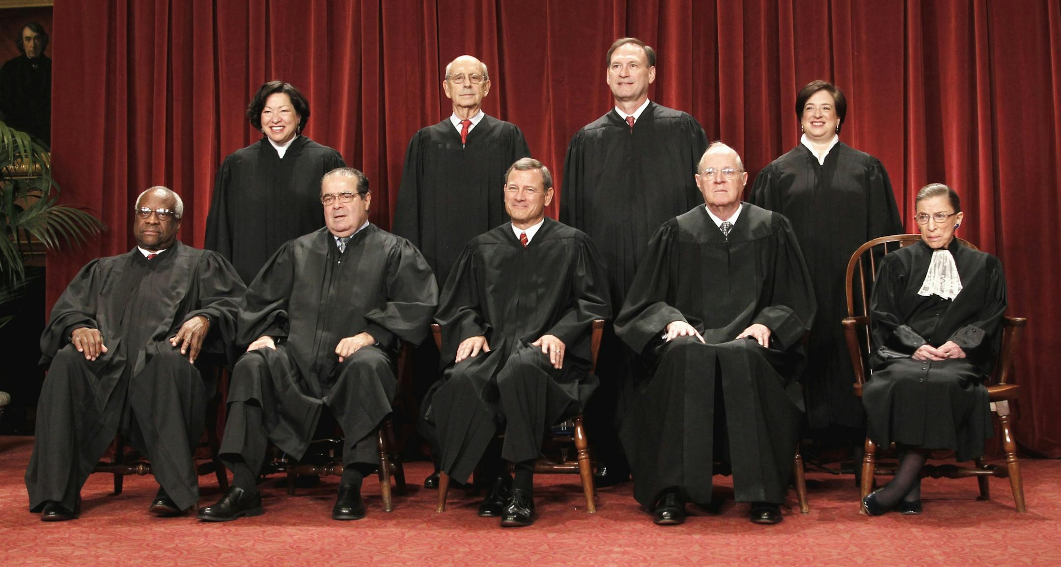 FILE - This Oct. 8, 2010 file photo shows the justices of the U.S. Supreme Court at the Supreme Court in Washington. Seated from left are Associate Justices Clarence Thomas, and Antonin Scalia, Chief Justice John Roberts, Associate Justices Anthony M. Kennedy and Ruth Bader Ginsburg. Standing, from left are Associate Justices Sonia Sotomayor, Stephen Breyer, Samuel Alito Jr., and Elena Kagan. The Supreme Court on Thursday, June 28, 2012, upheld the individual insurance requirement at the heart o